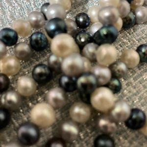Super long single strand necklace with white, gray and black cultured pearls.